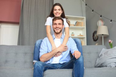 Güzel kadın ile erkek arkadaşı harcama kaliteli zaman birlikte kanepede evde oturma odasında.