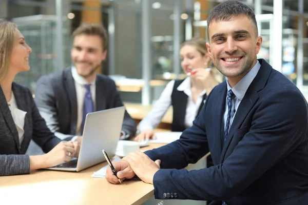 Zakenman met collega 's op de achtergrond. — Stockfoto