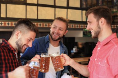 Eğleniyor ve pub bar sayacı, fıçı bira içme neşeli eski dostlar.