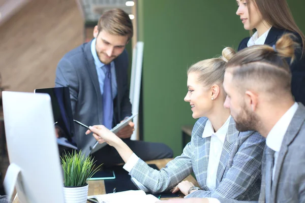 Equipo de negocios de inicio en la reunión en la oficina brillante moderna lluvia de ideas interior, trabajando en tabletas y computadoras PC . — Foto de Stock