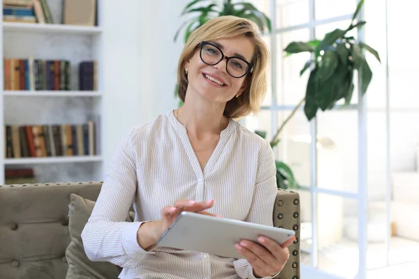 Mujer Alegre Mediana Edad Sentada Sofá Usando Aplicaciones Tabletas Computadora — Foto de Stock