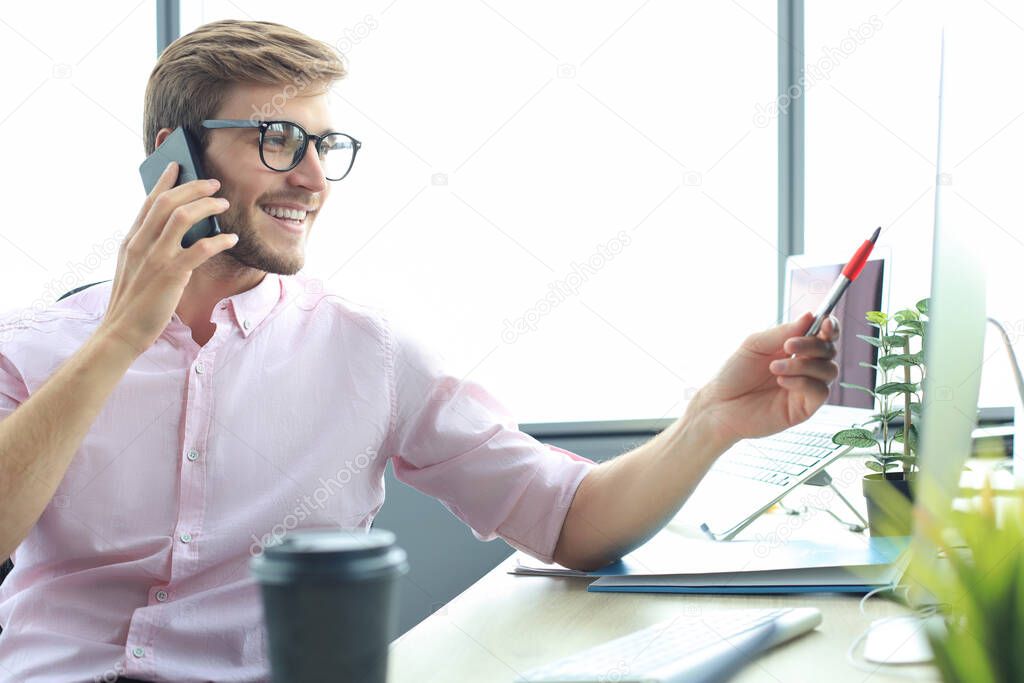 Businessman using his mobile phone in the office