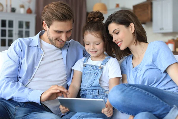 Pais Jovens Amigáveis Positivos Com Pequena Filha Sorridente Sentada Sofá — Fotografia de Stock