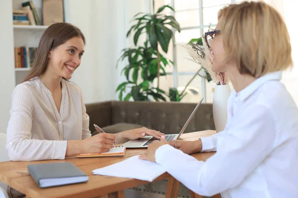 Professional middle aged female psychologist conducting a consultation