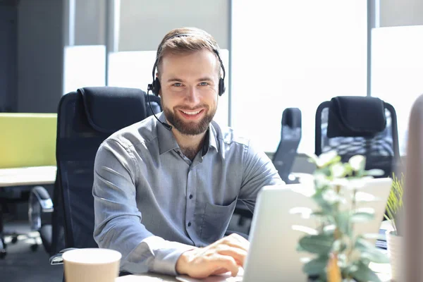 Operador Centro Llamadas Masculino Sonriente Con Auriculares Sentados Una Oficina — Foto de Stock