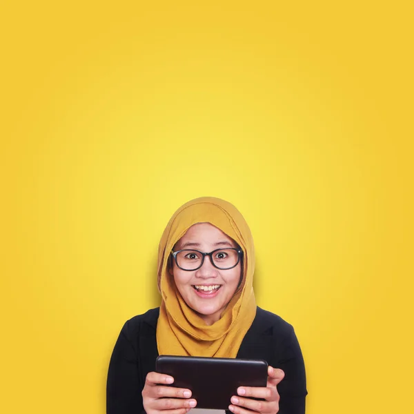 Young Asian businesswoman smiling expression, holding tablet. Close up body portrait. Orange Background