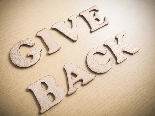 Give Back in wooden words letter, motivational self development business typography quotes concept