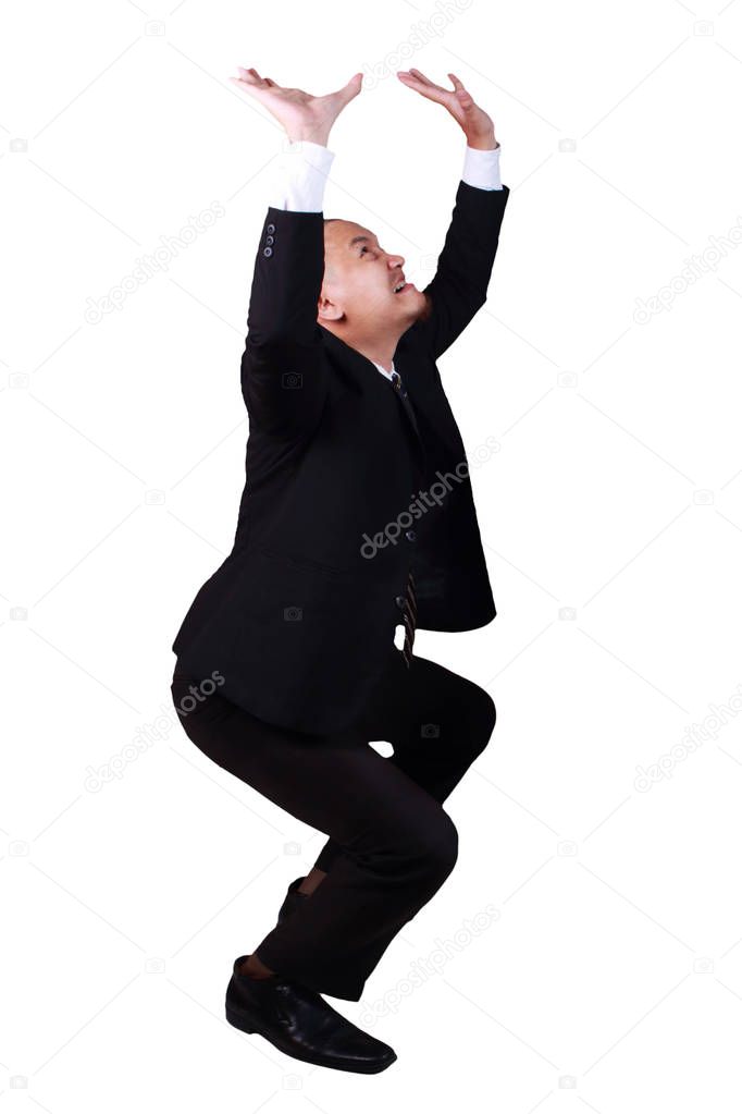 Businessman protects hands from what is falling from above. Man holding a heavy load. Isolated over white background