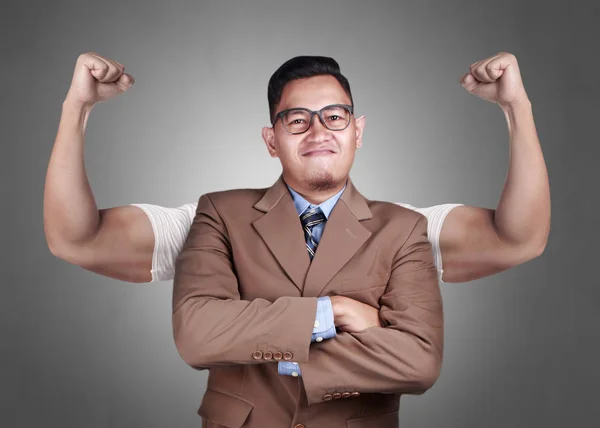 Business power concept. Young  Asian businessman  smiling with strong powerful arms drawn behind. Inner power authority