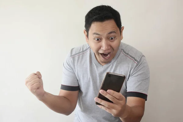 Shocked Happy Man Looking at Smart Phone