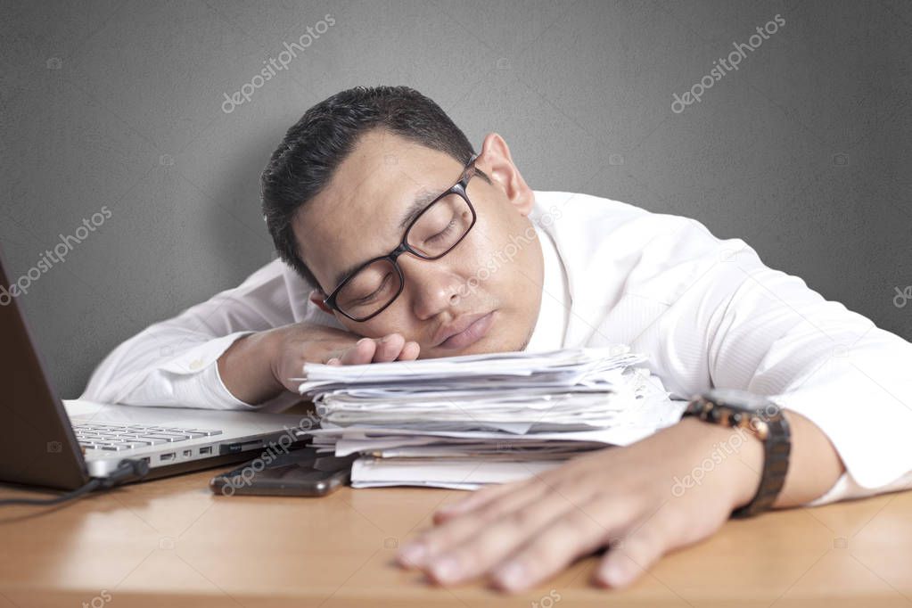 Tired Sleepy Asian Businessman Having Overworked