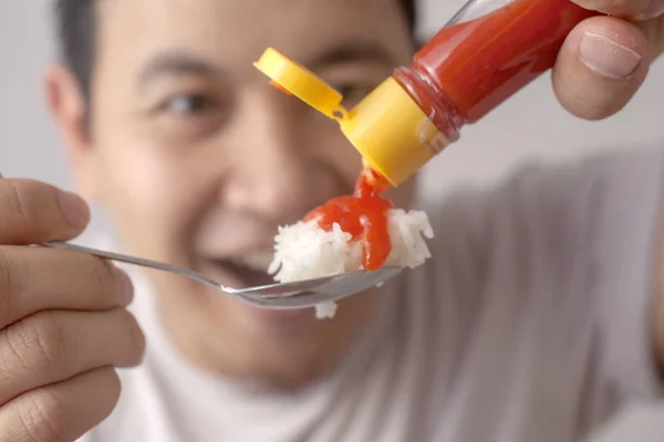 Asian Man Eating Rice with Sambal Chili Sauce