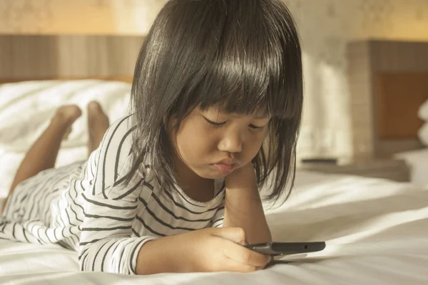 Little Girl Plays with Gadget Smart Phone