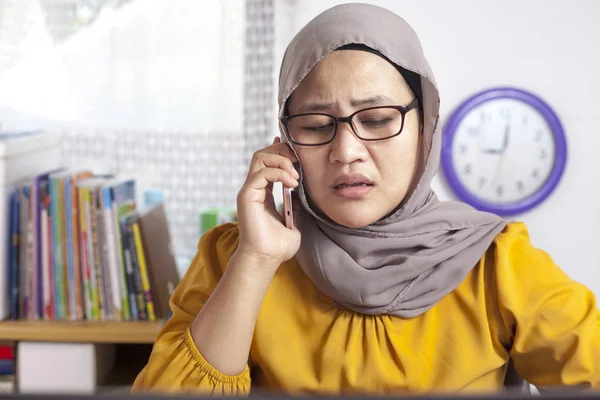 Young Asian businesswoman sad by phone call