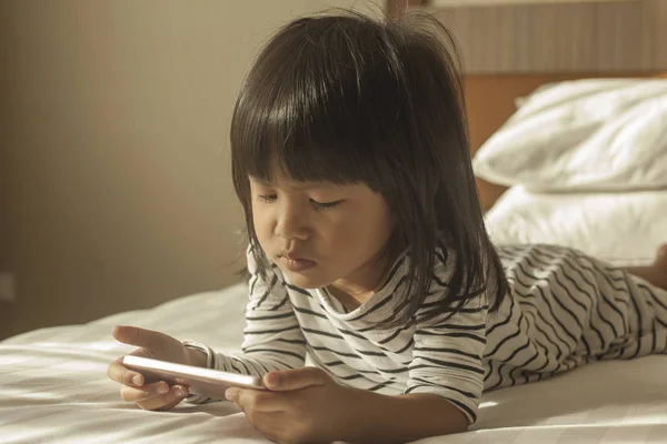 Little Girl Plays with Gadget Smart Phone