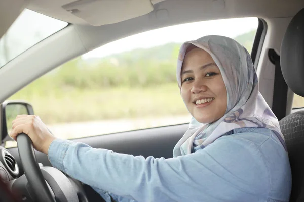 Muslim Lady Driving Her Car and Smiling