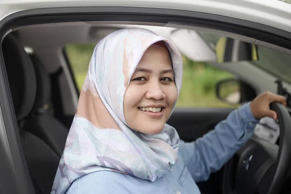 Muslim Lady Driving Her Car and Smiling