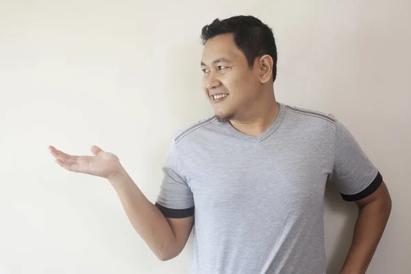 Young Man Showing Something on Empty Hand