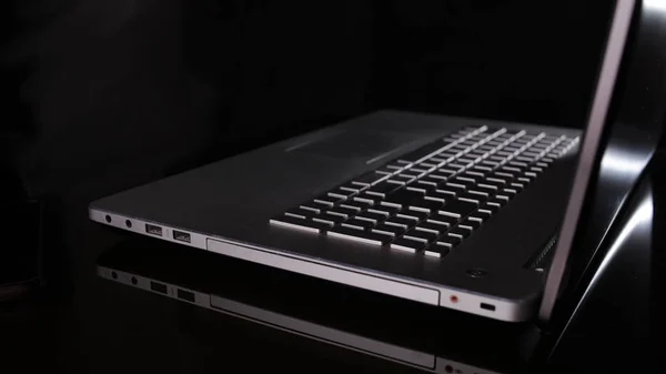 Silver Laptop in The Dark