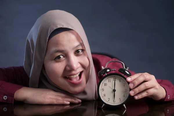 Femme musulmane tenant une horloge — Photo