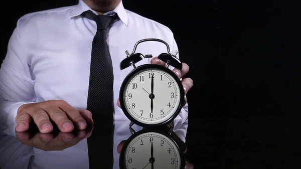 Businessman Holding Clock Pointing at Six O'Clock — Stock Photo, Image