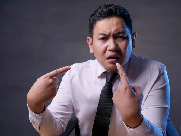 Asian Businessman Pointing Himself with Unhappy Expression as if