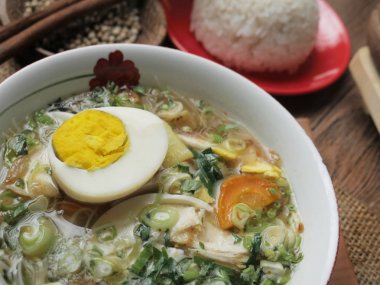 Indonesian chicken soto or soto ayam, served with white rice clipart