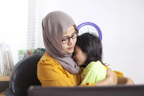 Single Mother Calms Her Baby at Work