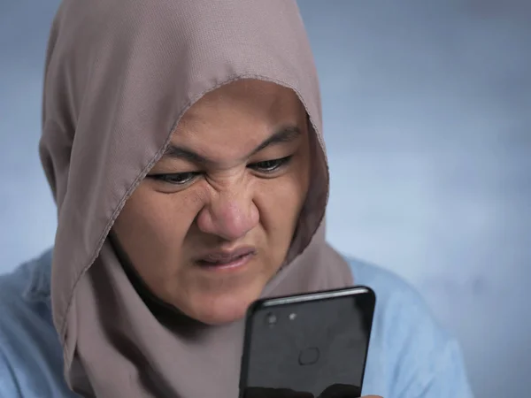 Young Muslim Woman Shocked Expression, Looking at Her Phone