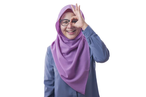 Muslimische Frau lächelt, schaut durch ihre Finger, ok Zeichen gestu — Stockfoto