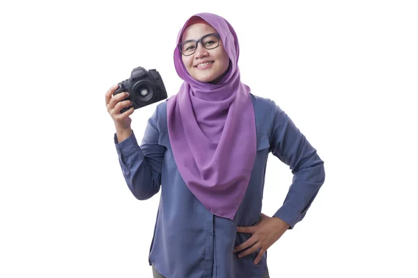 Feliz fotógrafa musulmana sosteniendo una cámara y sonriendo — Foto de Stock