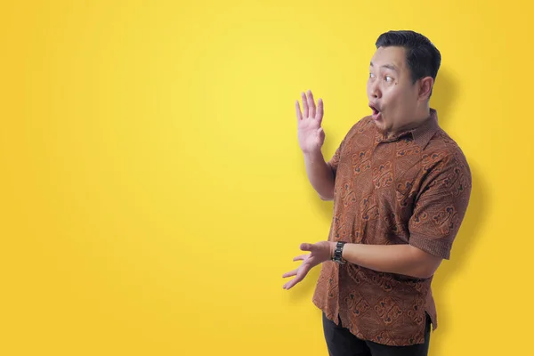 Asiático hombre usando batik camisa impactado a ver algo en su si — Foto de Stock