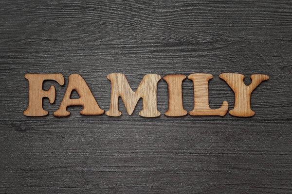 Family words text concept wooden letterpress type, on grunge background