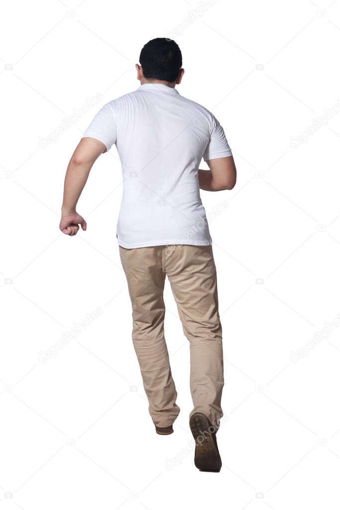 Full length portrait of Asian man wearing white shirt and khaki jeans standing running, rear view isolated on white