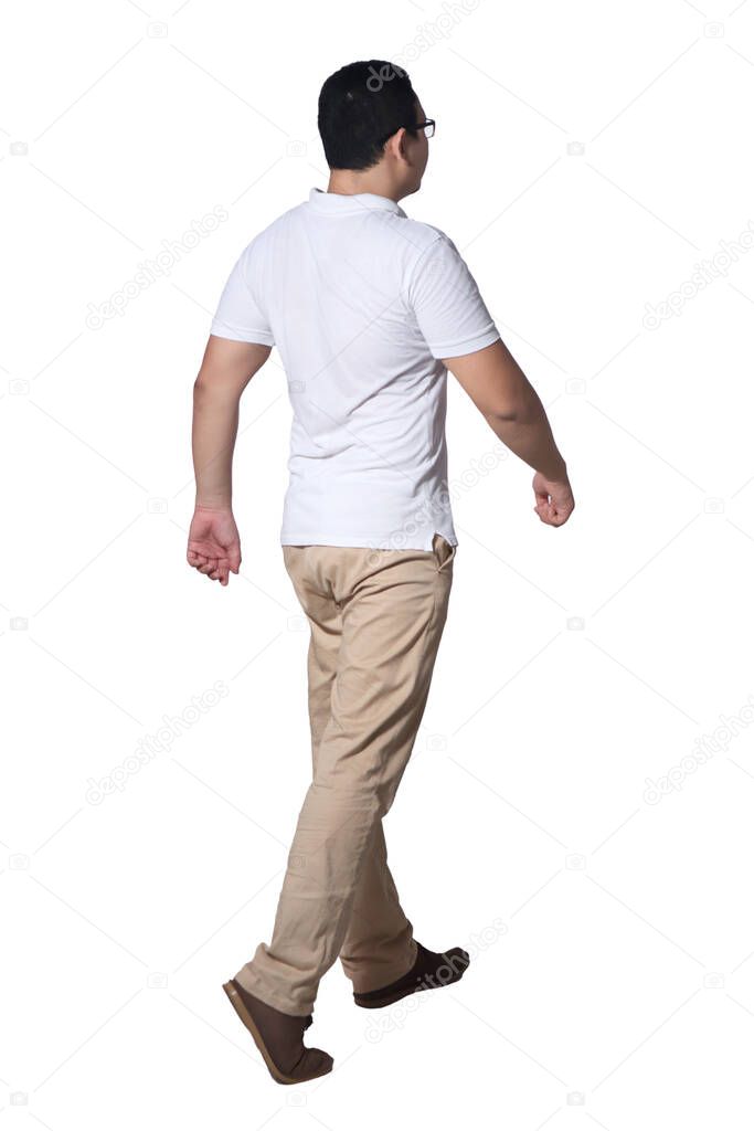 Full length portrait of Asian man wearing white shirt and khaki jeans standing walking, rear view isolated on white