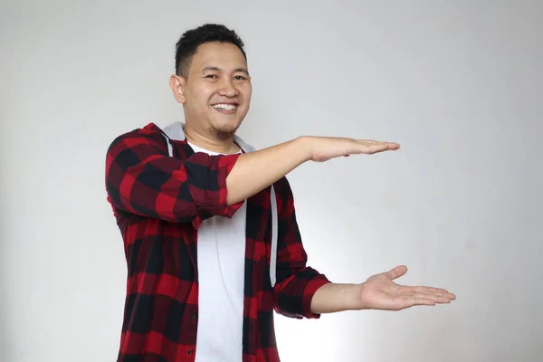 Elleri Arasında Bir Şey Gösteren Mutlu Genç Asyalı Adam Beyaz — Stok fotoğraf
