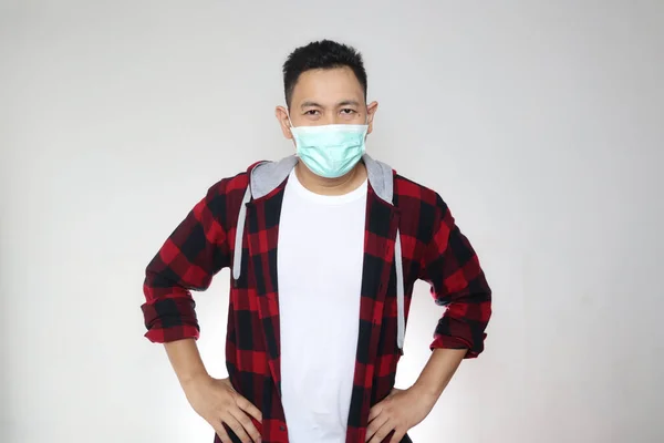 Asian man wearing facial mask, new normal during covid-19 coronavirus pandemic situation, isolated on white background