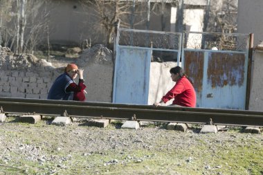 Köprüde koşan iki genç erkek ve kadın var.