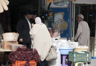 İki adam pazarda baharat satıyor.