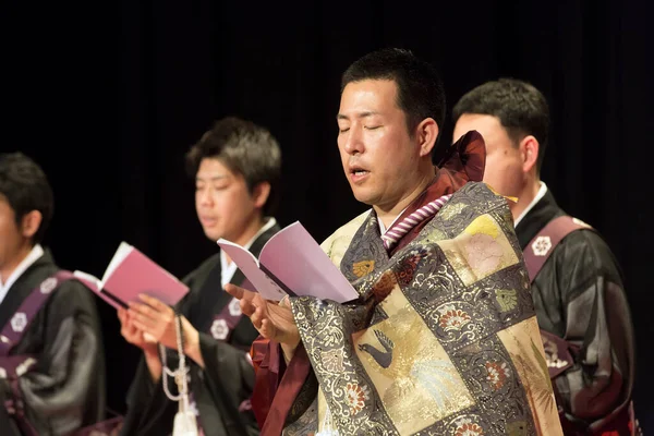 Japanese people performing in traditional style on stage