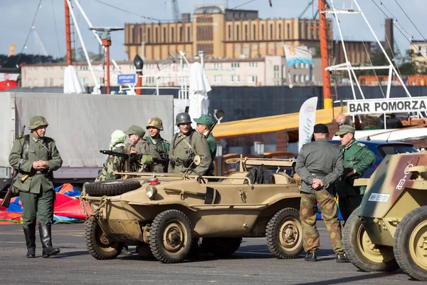 People in military uniform at harbor