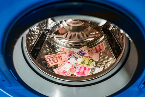 Banknotes in wash machine, close up view