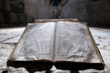 Sanahin, Armenia - July 15, 2014: Old bible in Sanahin monastery. clipart