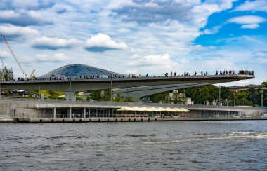 Moskova, Rusya. 20 Ağustos 2018: Sarjadje parkındaki nehir manzaralı güvertede ziyaretçiler duruyor.