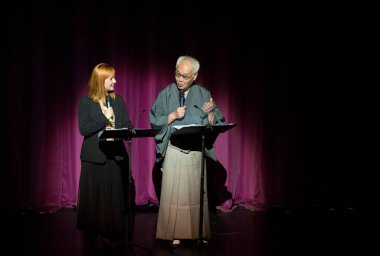 Kimliği belirsiz insanlar Japon tarzında tiyatro sahnelerinde oynuyorlar.