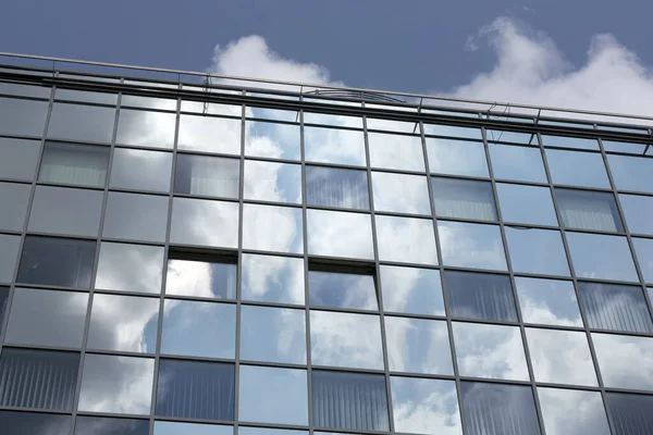 modern office building with reflection of clouds