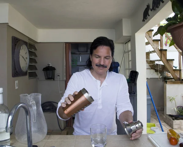 自宅で飲み物を注ぐヒスパニックの男 — ストック写真
