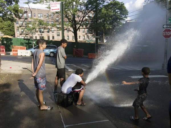 Kids play with water from open hydrand in summer — Stock Photo, Image