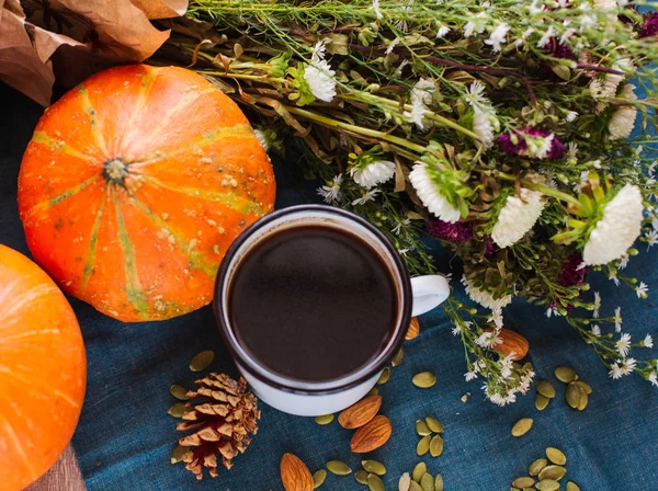Cozy Autumn Morning with Cup of Coffee, Decorative Pumpkins, Nuts, Cones. Halloween Mood