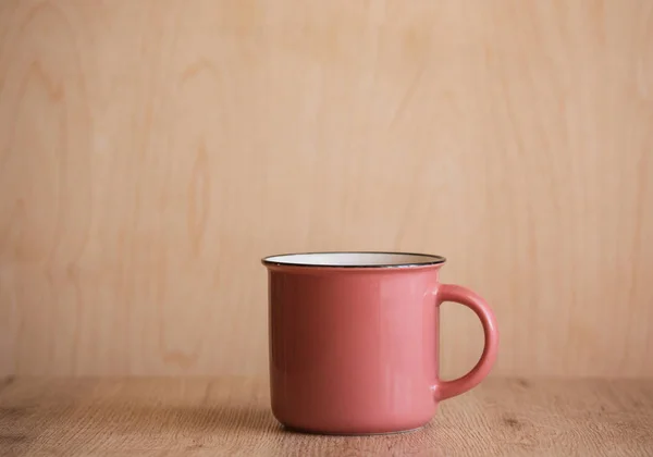 Pink Coffee Mug on Wooden Background. Isolited. Copy Space